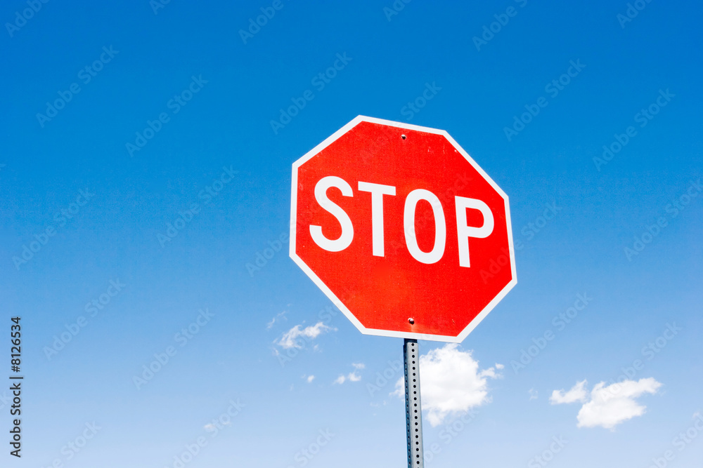 Stop sign against blue sky
