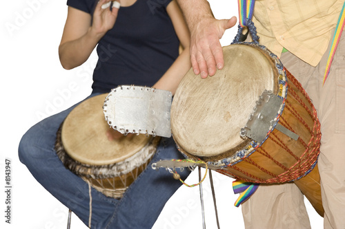 two men playing djembe