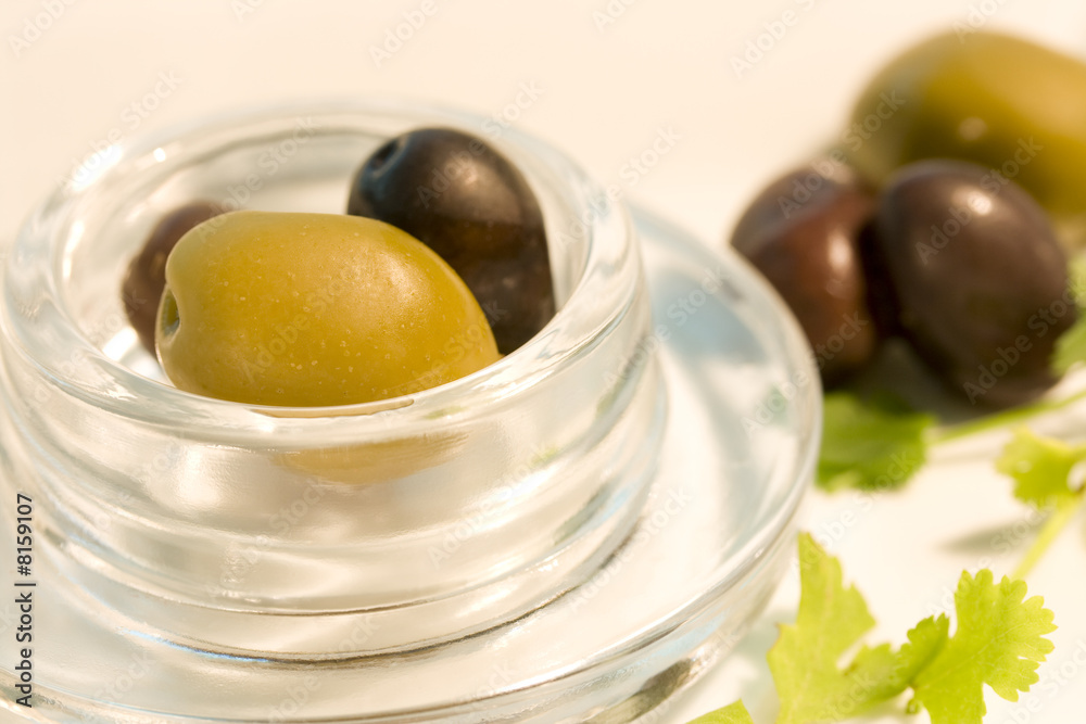 Black and green olives in glass bowl Black and green olives in glass bowl