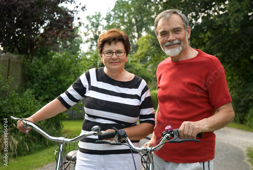 An attractive senior couple bicycling