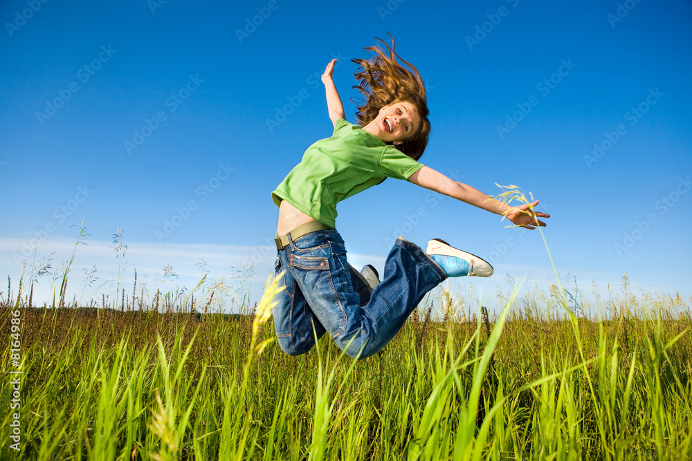 Happy young woman is jumping in a field Happy young woman is jumping in a field