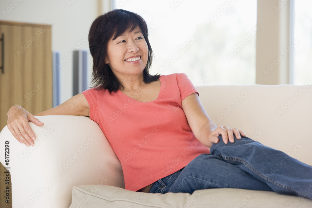 Woman relaxing in living room smiling Woman relaxing in living room smiling