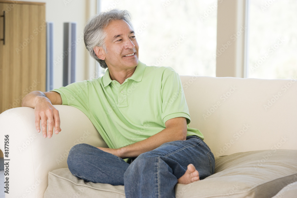 Man sitting in living room smiling Man sitting in living room smiling