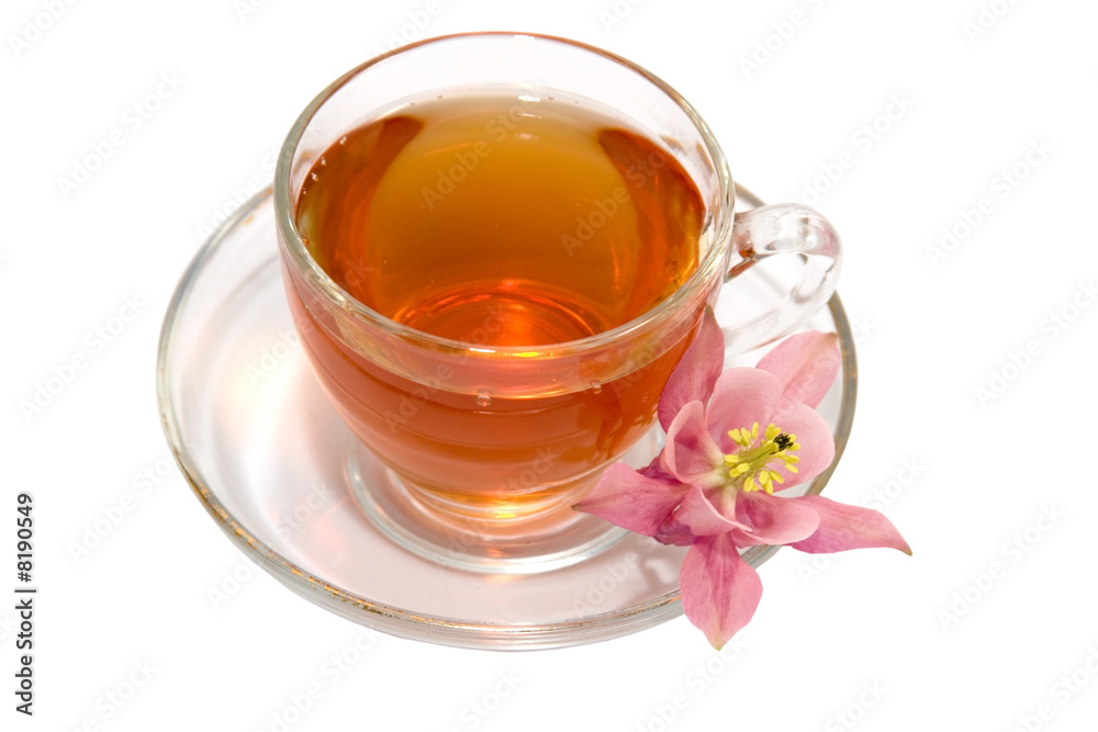 Transparent teacup with tea and flower