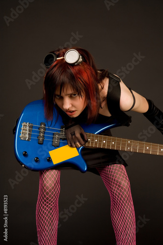 Sensual rock girl with bass guitar