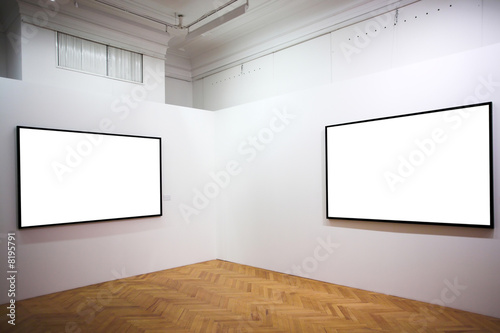 Two empty frames on white wall