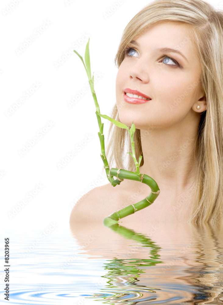 blue-eyed blonde with bamboo in water