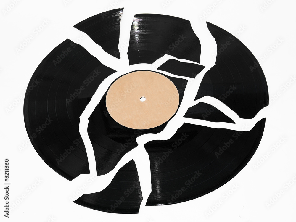 Naklejka premium Broken vinyl record against a white background