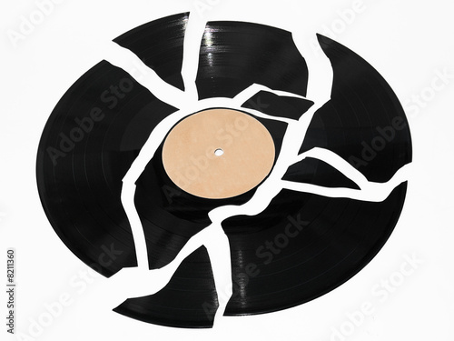 Broken vinyl record against a white background photo