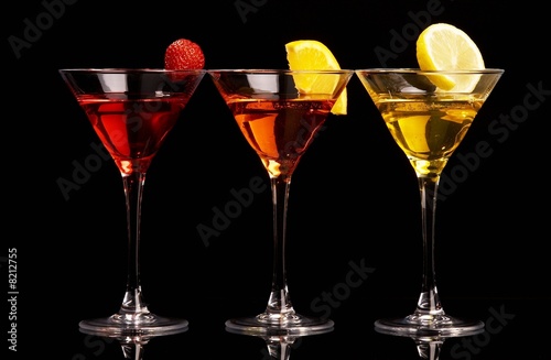 Three colorful cocktails with fruits on black background