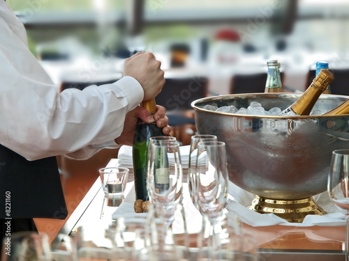 kellner bereitet sektflasche bankett gastronomie