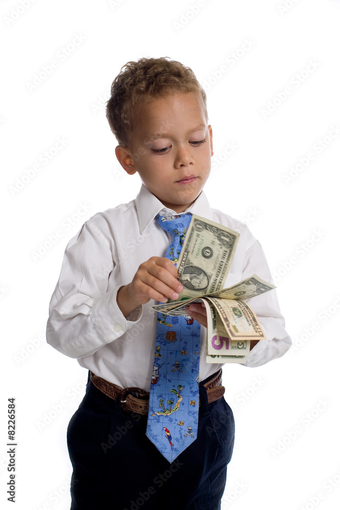 Young boy dressed as businessman holds money - isolated on white Young boy dressed as businessman holds money - isolated on white
