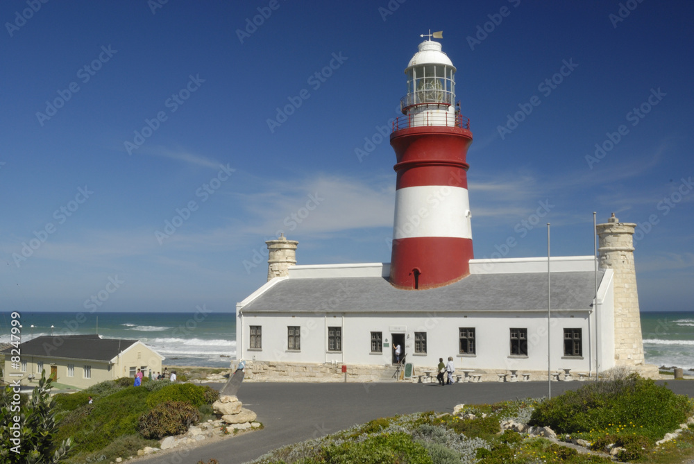 Agulhas Lighthouse at sunny day with blue sky. Negative space for your text