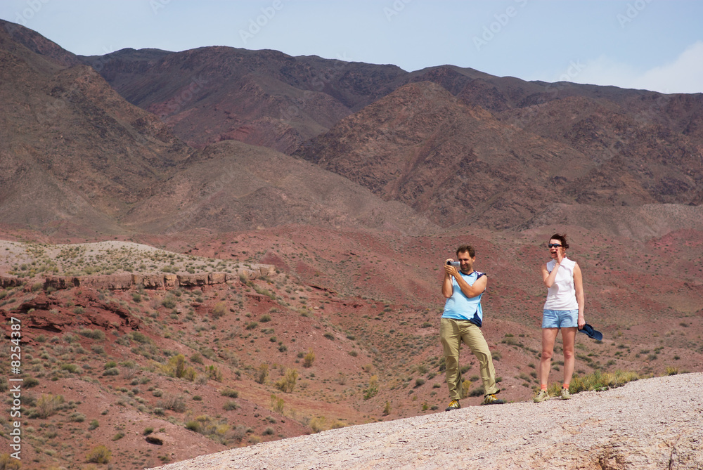 Couple walking in the desert mountains Couple walking in the desert mountains