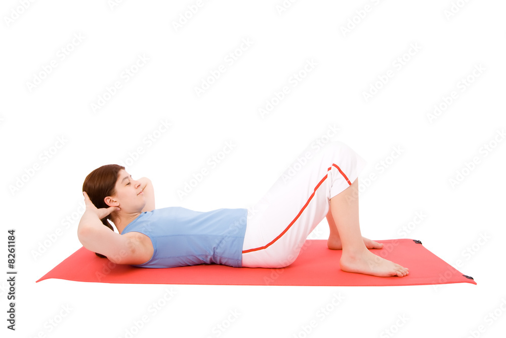 Young woman performing fitness exercises in the ground.