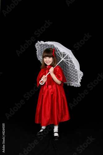 Girl in red holding white parasol