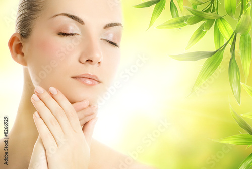 Beautiful young woman applying organic cosmetics to her skin #8266929