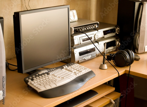 Work place with computer and audio equipment