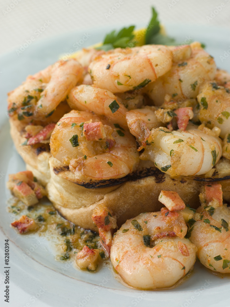 Toasted Brioche topped with Prawns cooked In Lobster Garlic Butt