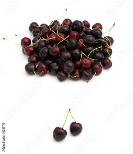 heap of sweet cherries and pair of them