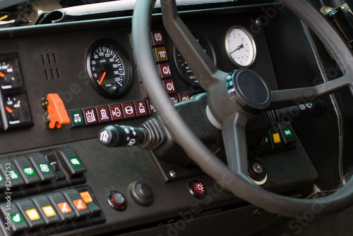 Steering wheels and controls in cockpit of military vehicle © ventura