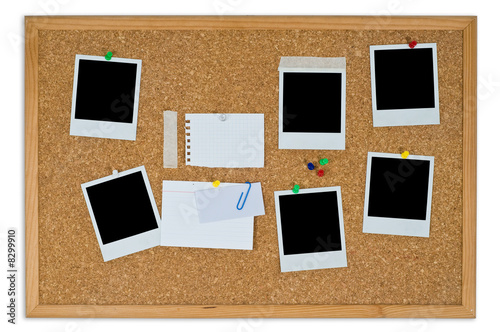 Cork board with blank instant photos and notes