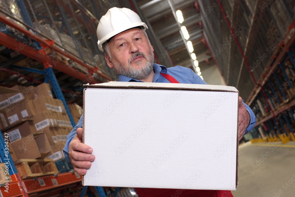 older worker in uniform  carrying parcel in warehouse