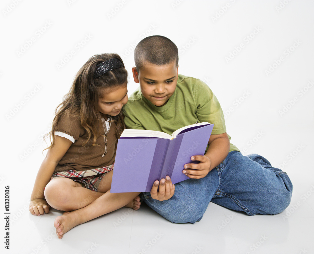 Boy and girl reading book.