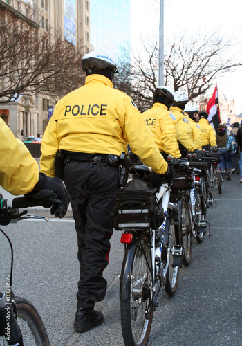 power riot police lined up and moving in on a crowd of anti war