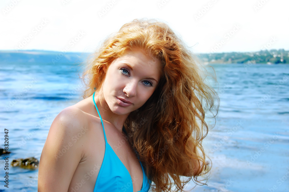 portrait of beatiful redhead girl over blue waters portrait of beatiful redhead girl over blue waters