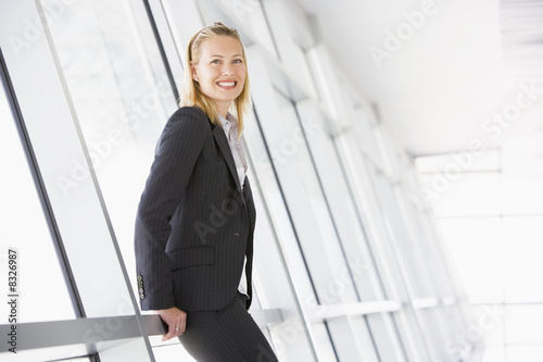 Vászonkép Businesswoman standing in corridor smiling