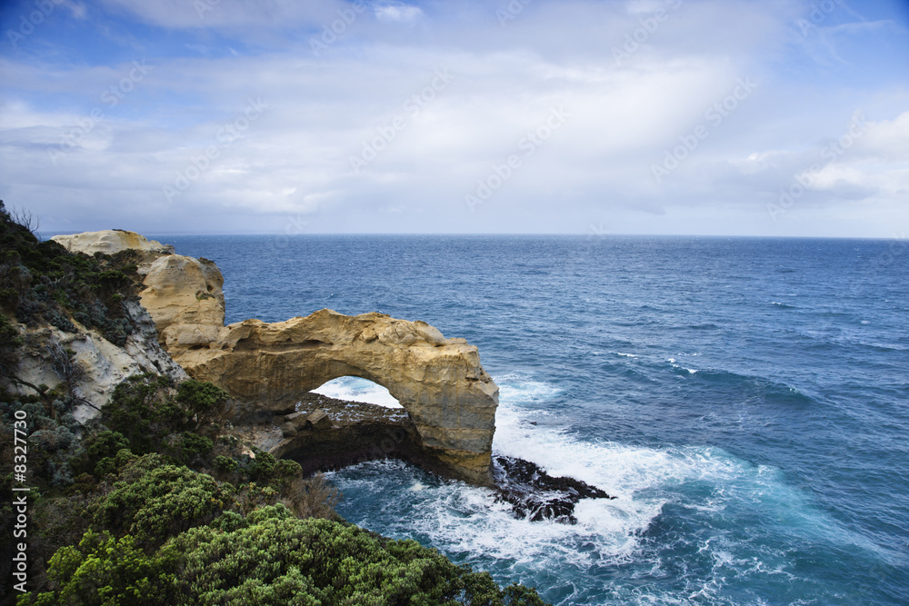 Rock arch in ocean.