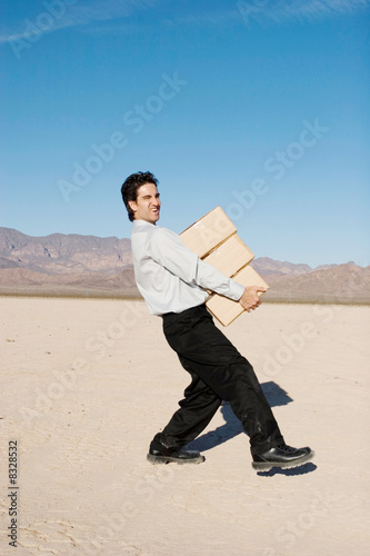 Businessman carrying boxes