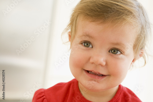 Baby indoors smiling