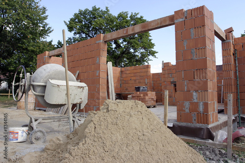 A brick layer putting down another row of bricks