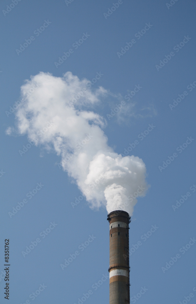 smoke stack against blue sky