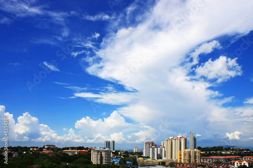 Cityscape Over Cloudy Blue Sky