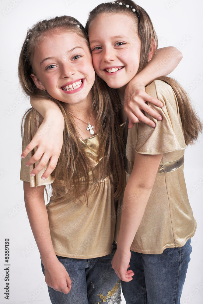 Two little  girls hugging each other