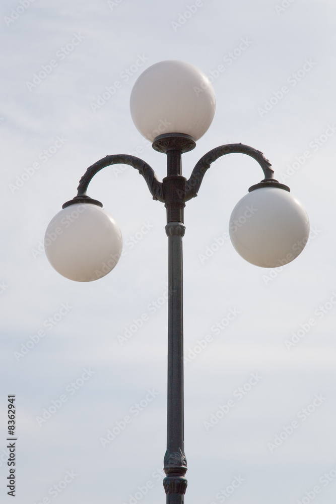 Lantern with three glass spheres on quay