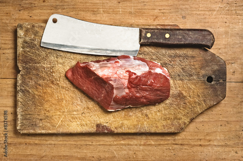 Butcher kife and raw meat, studio shot.
