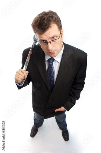 Billede på lærred Impertinent businessman with wrench waiting on white background