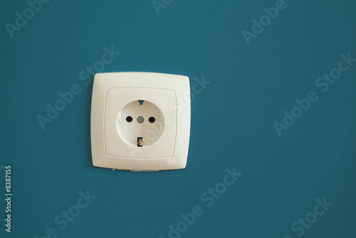 Electric outlet on blue gray background