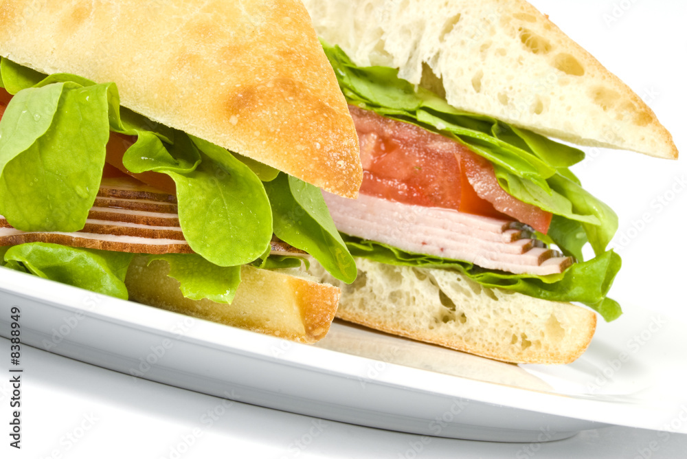 Obraz premium Focaccia Sandwich with Ham on a White Plate