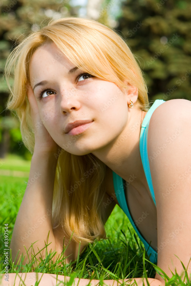 pretty woman rest on the green grass pretty woman rest on the green grass