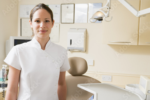 Fototapeta Naklejka Na Ścianę i Meble -  Dental assistant in exam room smiling