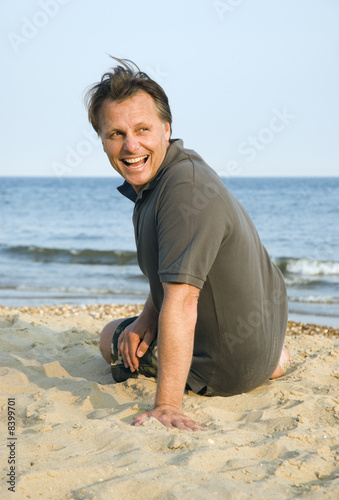 A happy laughing fories man on beach. © Andrew Lever