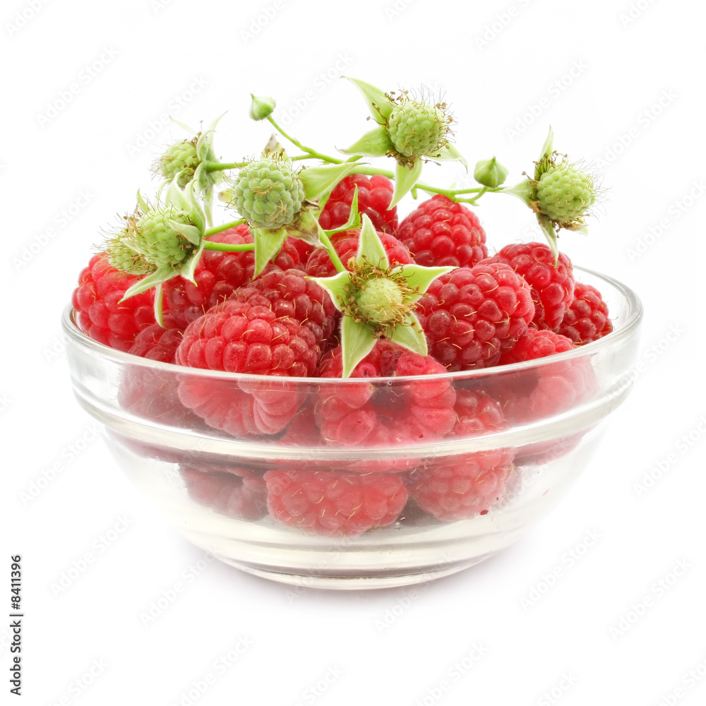 red raspberry fruits in glass vase