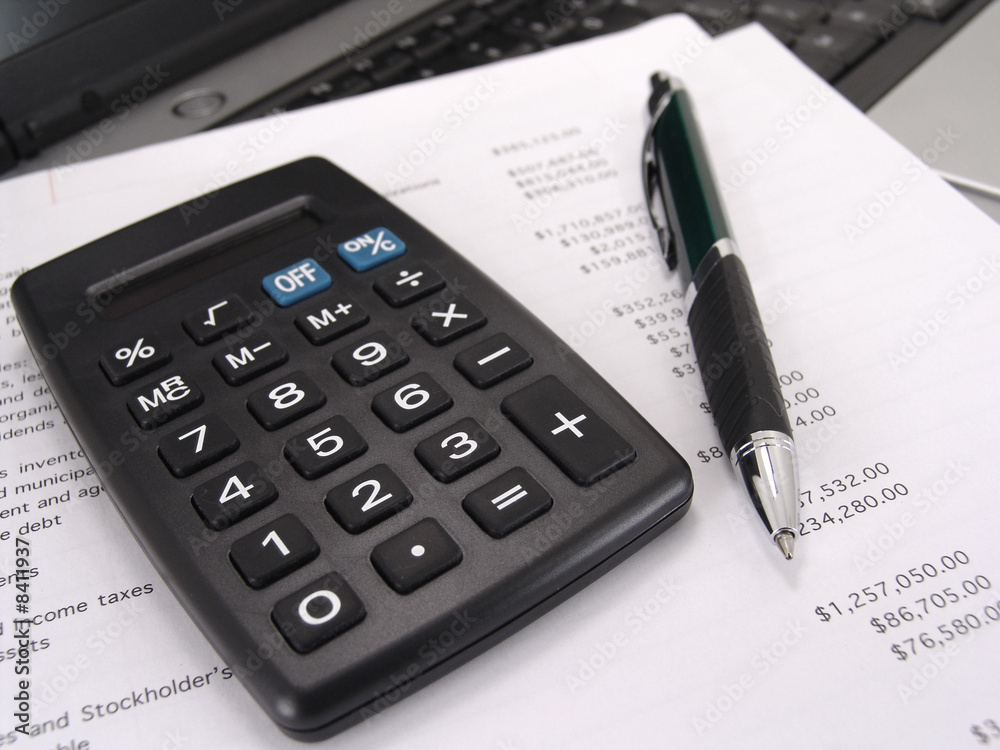 calculator and pen with balance sheet calculator and pen with balance sheet