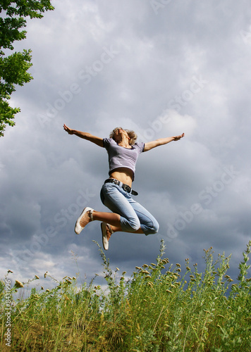 Happy young woman jumps