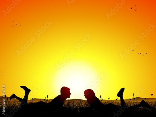 couple on a field at sunset